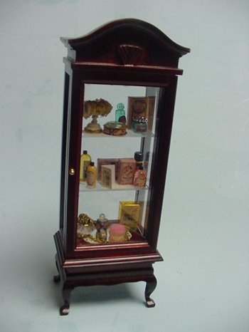 Tall Glass Display Cabinet filled with Perfumes
