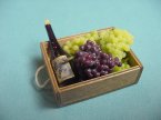 A Crate w/grapes and a Bottle of Wine